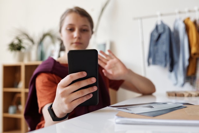 student interacting via video on mobile device