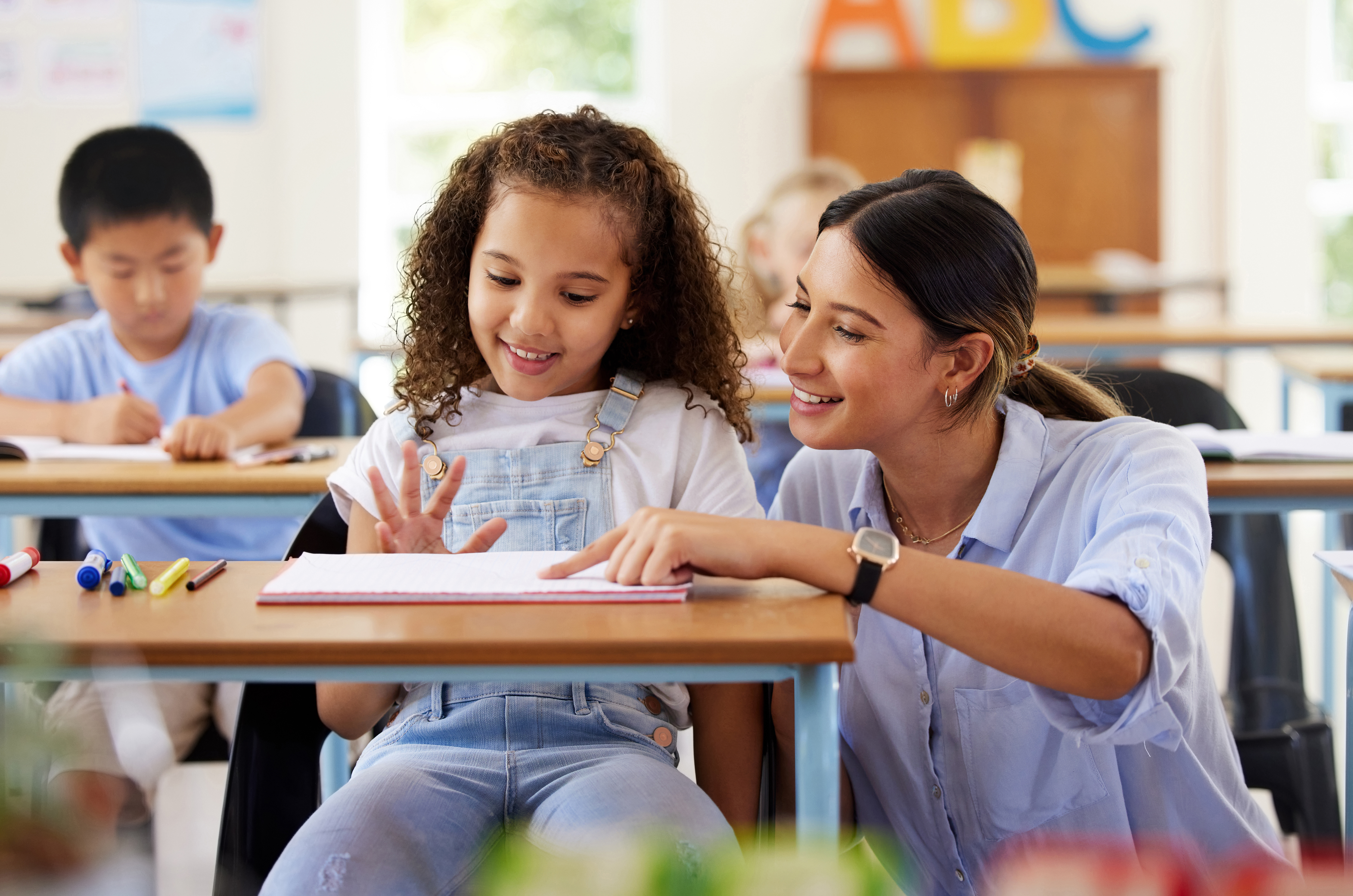 Teaching assistant working with student