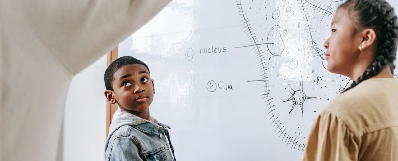 students trying to figure out a problem on the board